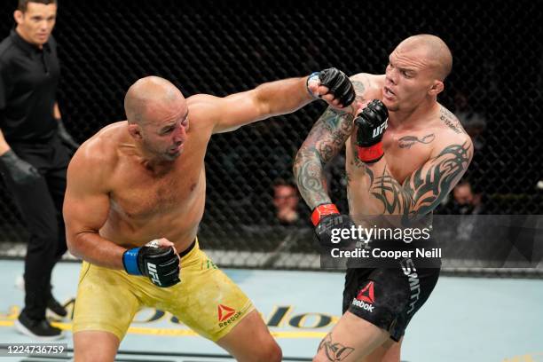 Glover Teixeira of Brazil punches Anthony Smith in their light heavyweight bout during the UFC Fight Night Event at VyStar Veterans Memorial Arena on...