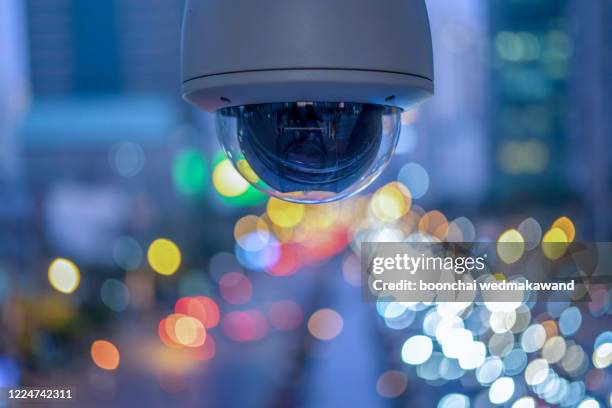 cctv overhead for security on the road or in town and with soft car and building background. - camera de surveillance photos et images de collection