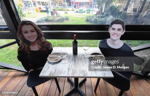 Cardboard cutouts of human beings sitting at tables inside the Five Dock Dining restaurant on May 14, 2020 in Sydney, Australia. Restaurants and...