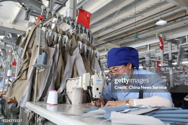 Employees make work suits at a garment factory operated by China National Nuclear Corporation on May 14, 2020 in Tongxin County, Ningxia Hui...