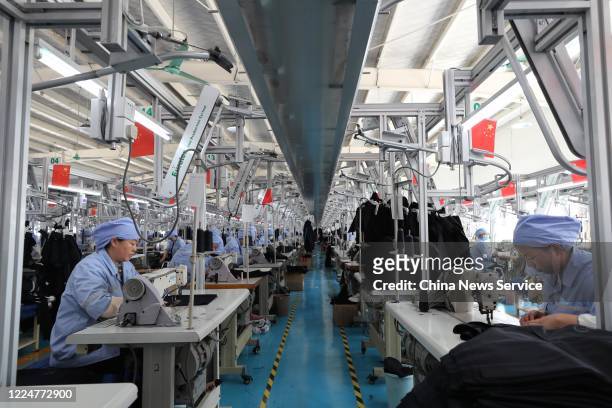 Employees make work suits at a garment factory operated by China National Nuclear Corporation on May 14, 2020 in Tongxin County, Ningxia Hui...