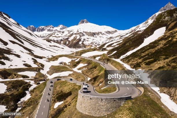 traffic along the hairpin road toward the oberalp pass between the canton of uri and graubünden in the alps moutains in switzerland - car and motorcycle on mountain road stock pictures, royalty-free photos & images