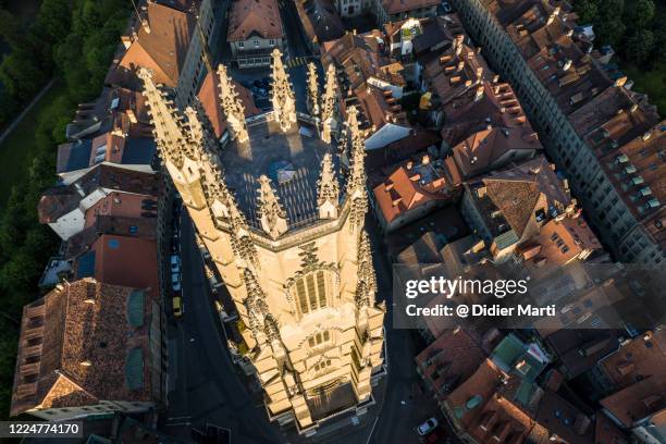 dramatic aerial view of the gothic fribourg cathedral in switzerland - fribourg canton stock pictures, royalty-free photos & images