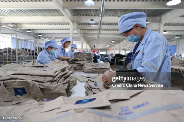 Employees make work suits at a garment factory operated by China National Nuclear Corporation on May 14, 2020 in Tongxin County, Ningxia Hui...