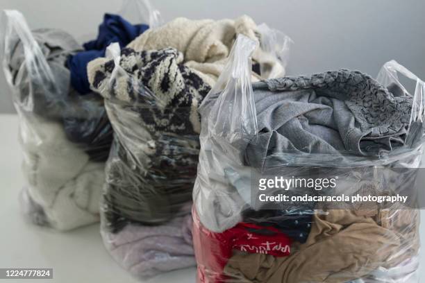 bags of clothes - clothes waste stock pictures, royalty-free photos & images