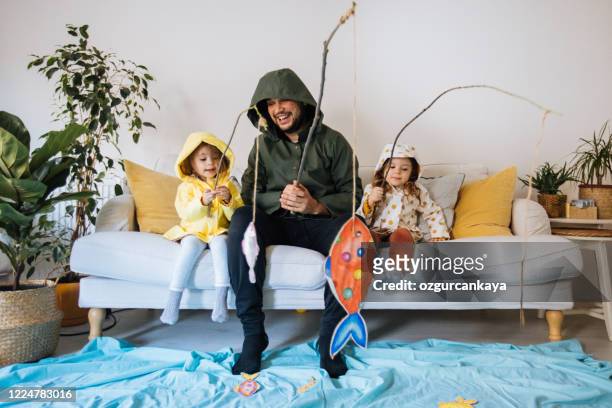 kids with father playing fishing at home - home interior stock pictures, royalty-free photos & images