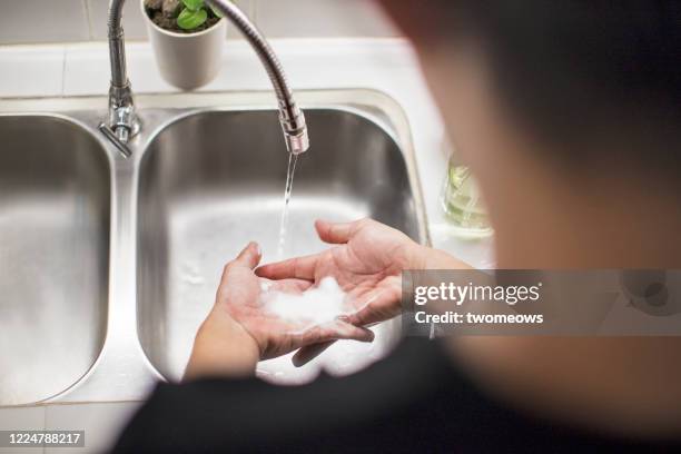 home hand washing and disinfection lifestyle image - washing hands close up stock pictures, royalty-free photos & images
