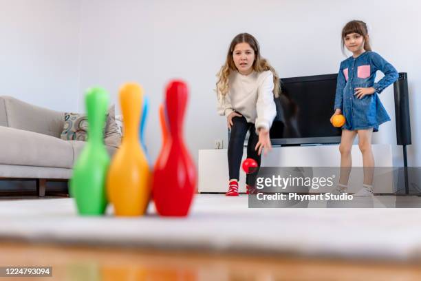girls playing bowling at home - kids bowling stock pictures, royalty-free photos & images