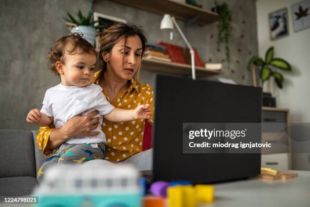 nervous mother multi-tasking while working from home - stressed mother stock pictures, royalty-free photos & images