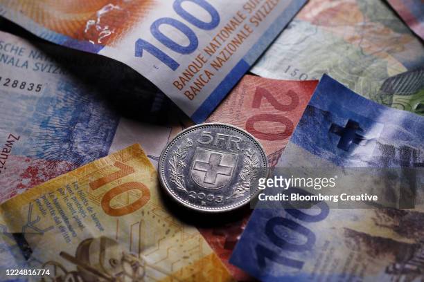 swiss franc banknotes and coin - swiss stock pictures, royalty-free photos & images