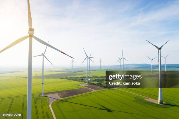 aerial view of wind turbines and agriculture field - global warming stock pictures, royalty-free photos & images