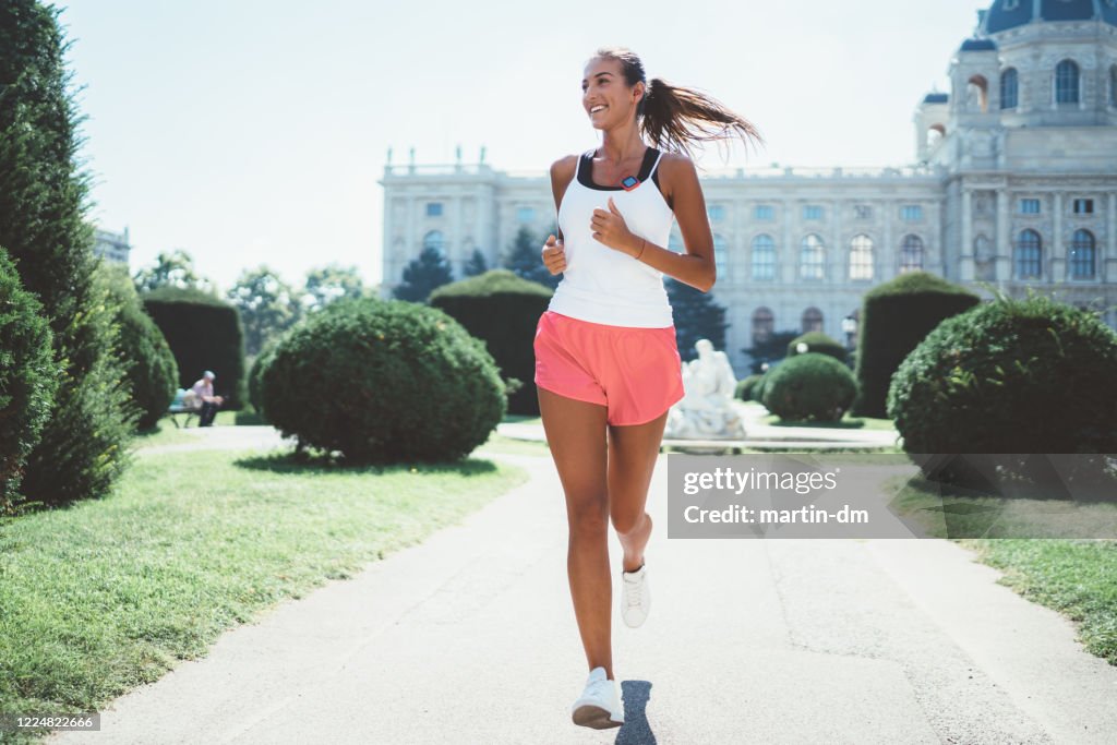 Sportswoman jogging in the city park