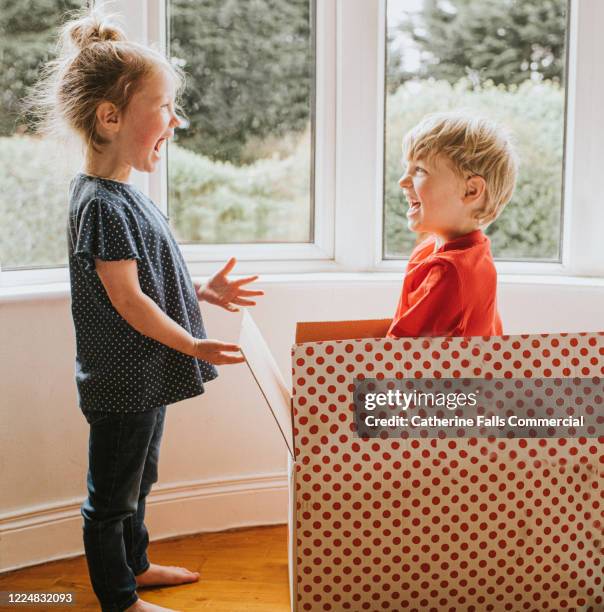 playing in a box - children funny moments stock pictures, royalty-free photos & images