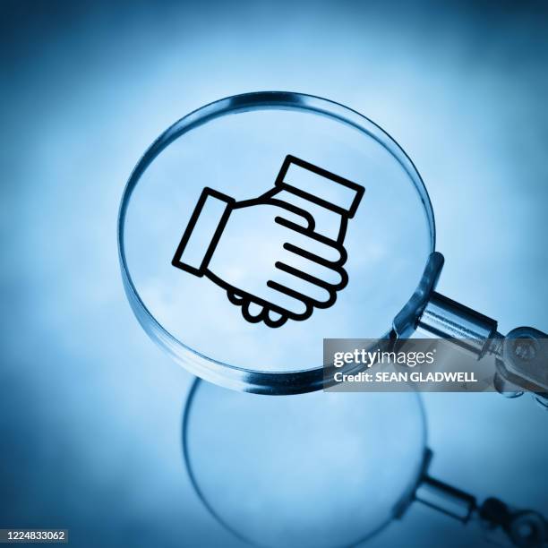 handshake under magnifying glass - meeting icon stock pictures, royalty-free photos & images