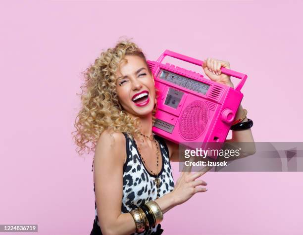 cheerful woman in 80's style outfit holding boom box - pop musician stock pictures, royalty-free photos & images