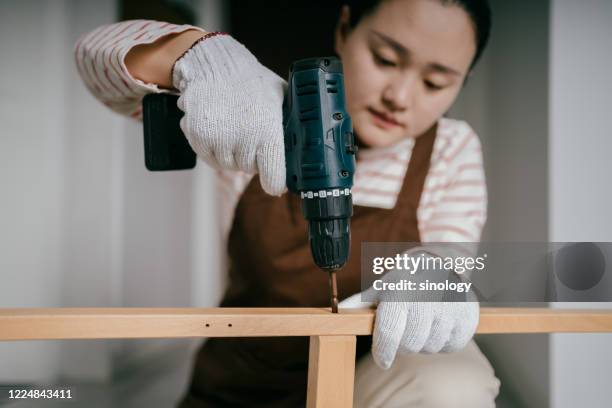 asia women building a table in home - lockdown drill stock pictures, royalty-free photos & images