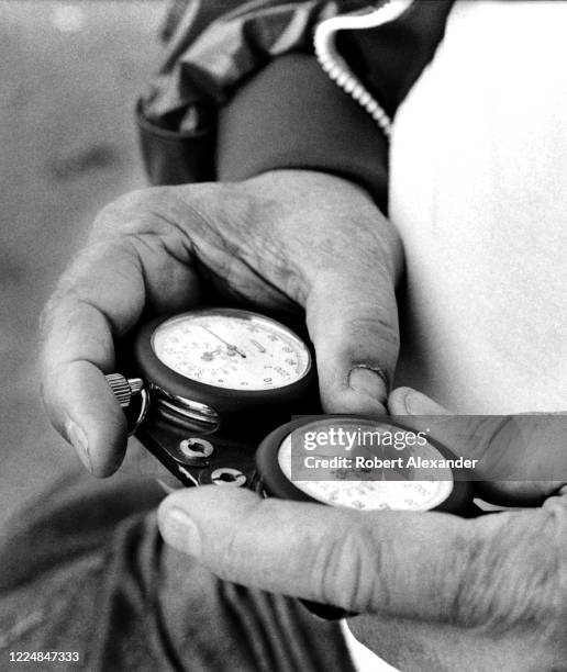 Veteran NASCAR driver and car owner Junior Johnson uses a stopwatch to time his car's speed around the racetrack during a practice session prior to...