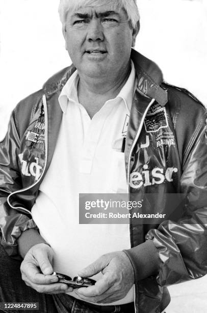 Veteran NASCAR driver and car owner Junior Johnson uses a stopwatch to time his car's speed around the racetrack during a practice session prior to...