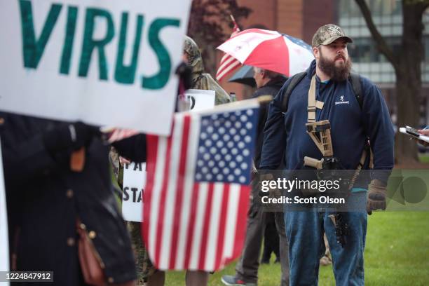 Demonstrators hold a rally in front of the Michigan state capital building to protest the governor's stay-at-home order on May 14, 2020 in Lansing,...