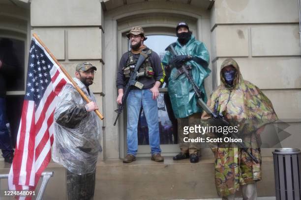 Armed demonstrators attend a rally in front of the Michigan state capital building to protest the governor's stay-at-home order on May 14, 2020 in...