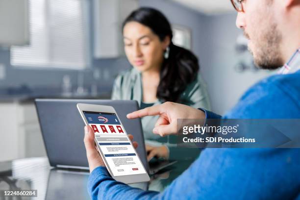 man voting online - online voting stock pictures, royalty-free photos & images
