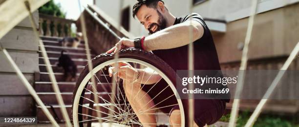 man repairing bicycle diy - bicycle tire stock pictures, royalty-free photos & images