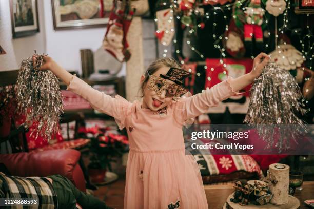 happy little girl enjoying new years party at home - sparkle children stock pictures, royalty-free photos & images