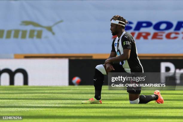 Newcastle United's French midfielder Allan Saint-Maximin takes a knee to protest against racism and show solidarity with the Black Lives Matter...