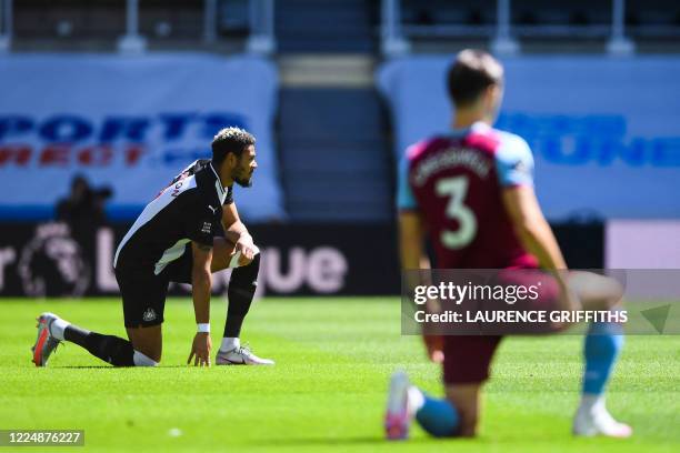 Newcastle United's Brazilian striker Joelinton takes a knee to protest against racism and show solidarity with the Black Lives Matter movement before...