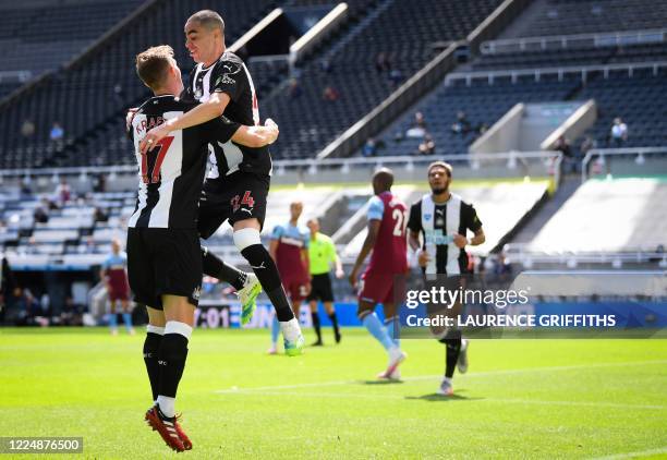 Newcastle United's Paraguayan midfielder Miguel Almiron celebrates with Newcastle United's Swedish defender Emil Krafth after scoring a goal during...