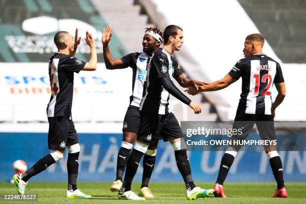 Newcastle United's Paraguayan midfielder Miguel Almiron celebrates with Newcastle United's French midfielder Allan Saint-Maximin and teammates after...