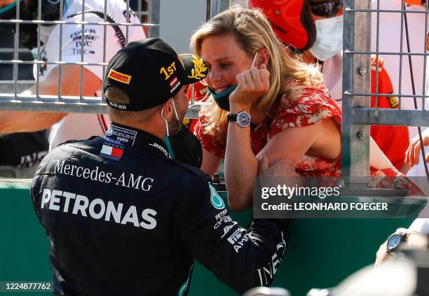 Mercedes' Finnish driver Valtteri Bottas celebrates with Tiffany Cromwell after the Austrian Formula One Grand Prix race on July 5, 2020 in...