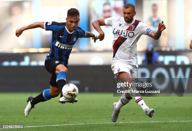 Lautaro Martinez of FC Internazionale competes for the ball with Danilo Larangeira of Bologna FC during the Serie A match between FC Internazionale...