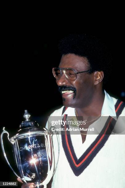 Lancashire Captain Clive Lloyd celebrates as he holds the first Lambert and Butler Cup after the final night cricket match against Leicestershire in...