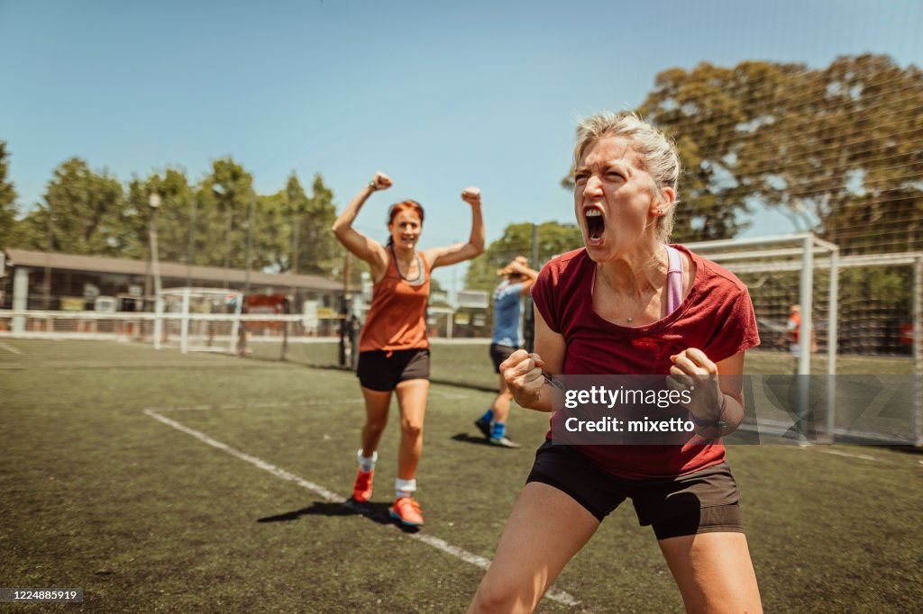 Female soccer team celebrating victory