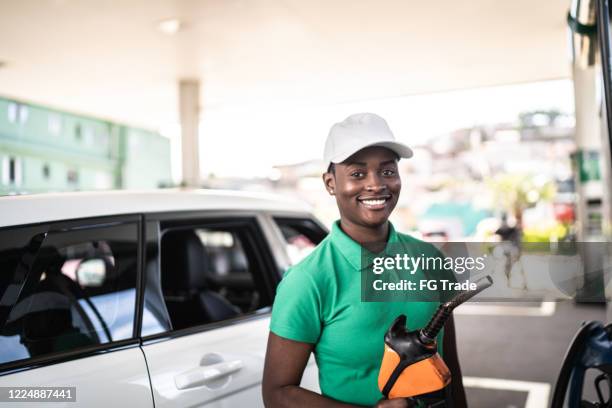 portrait of female gas station attendant at work - stereotypically brazilian stock pictures, royalty-free photos & images