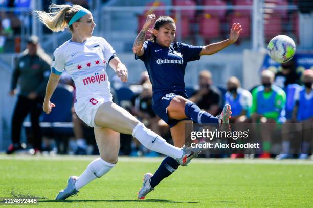 Julie Ertz of Chicago Red Stars races Debinha of North Carolina Courage to the ball during a game on day 5 of the NWSL Challenge Cup at Zions Bank...