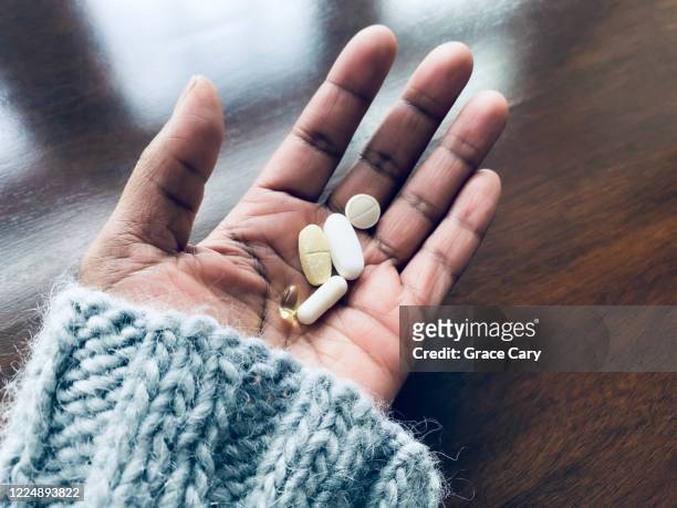 woman holds nutritional supplements - handful stock pictures, royalty-free photos & images