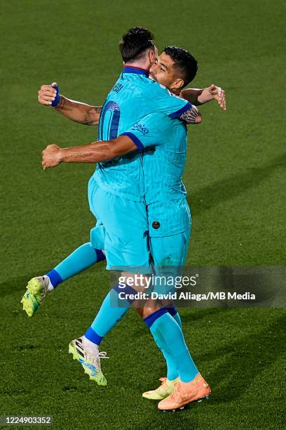 Luis Suarez of FC Barcelona celebrates his side's second goal with his teammate Leo Messi during the Liga match between Villarreal CF and FC...