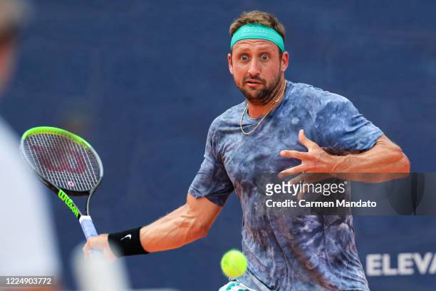 Tennys Sandgren of the United States returns a ball during the singles match against Taylor Fritz of the United States during the final day of the...