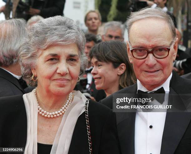 Italian composer Ennio Morricone and his wife Maria Travia pose 25 May 2007 upon arriving at the Festival Palace in Cannes, southern France, for the...