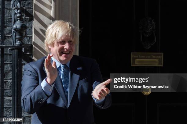 British Prime Minister Boris Johnson claps hands outside 10 Downing Street during the nationwide applause for the NHS staff on the 72nd anniversary...