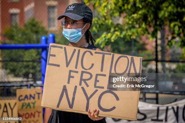 Participant holding a Eviction Free NYC sign at the protest.Tenants and Housing Activists gathered at Maria Hernandez Park for a rally and march in...