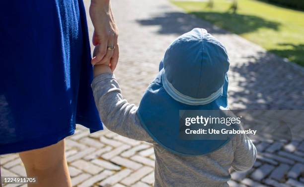 In this photo illustration a toddler is walks holding his mothers hand on June 22, 2020 in Oostkapelle, Netherlands.