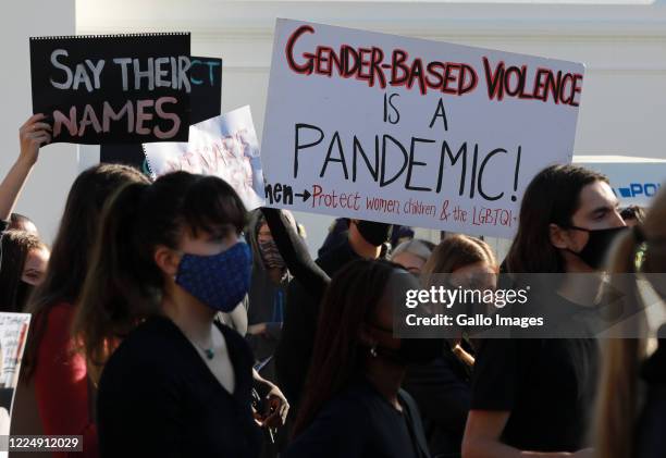 Protesters wearing face masks to protect against the coronavirus, seen during a gender based violence protest outside parliament on June 30, 2020 in...