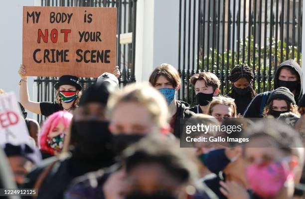 Protesters wearing face masks to protect against the coronavirus, seen during a gender based violence protest outside parliament on June 30, 2020 in...