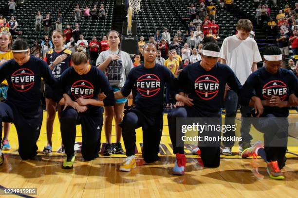 The Indiana Fever kneel during the national anthem before the game against the Phoenix Mercury during Round One of the 2016 WNBA Playoffs at Bankers...