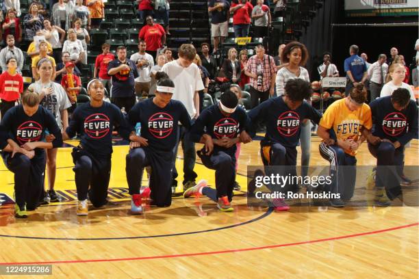 The Indiana Fever kneel during the national anthem before the game against the Phoenix Mercury during Round One of the 2016 WNBA Playoffs at Bankers...