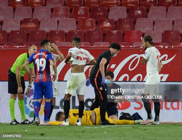 Sevilla's Czech goalkeeper Tomas Vaclik lays on the field after resulting injured during the Spanish League football match between Sevilla FC and SD...