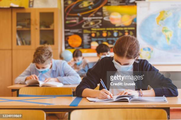 high school students at school, wearing n95 face masks. - high school stock pictures, royalty-free photos & images